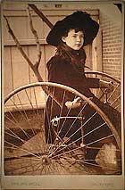 Young girl on hand powered tricycle
