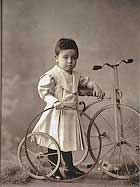 Child with hoop and tricycle