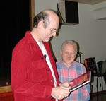 Simon Bell receives a gift book from Gerry Loban
